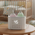 NuvioWarm™ dual smart baby bottle warmer and sterilizer for breast milk and formula, featuring 37°C temperature control and 100°C sterilization. Compact BPA-free design with LED touch display, preset timer, and fast PTC heating for modern parents. Ideal for newborn feeding, twins, and nighttime use – keeps bottles warm, clean, and safe.
